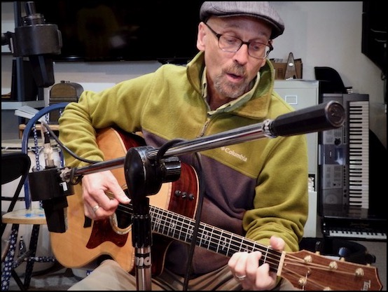 Man playing guitar in recording studio